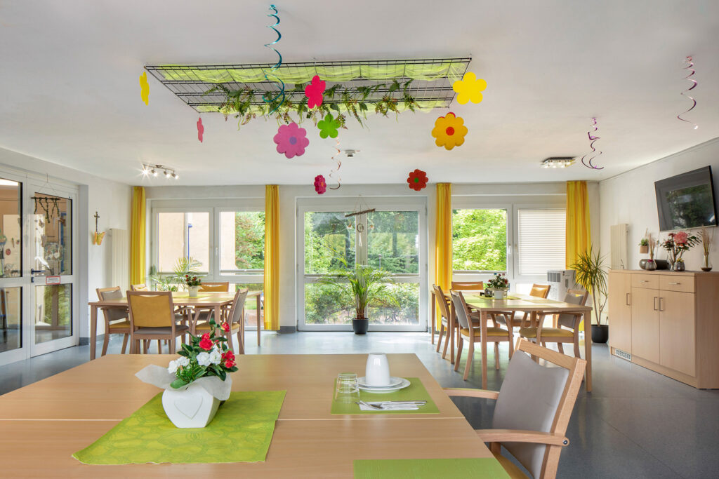 Blick in einen hellen, jahreszeitlich geschmückten Aufenthaltsraum.